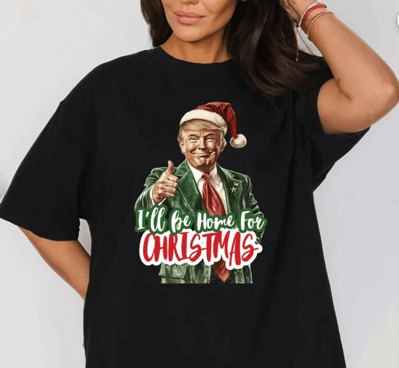 Woman wearing a black t-shirt with a festive "I'll Be Home For Christmas" Trump graphic printed using DTF transfer in Weston Florida.
